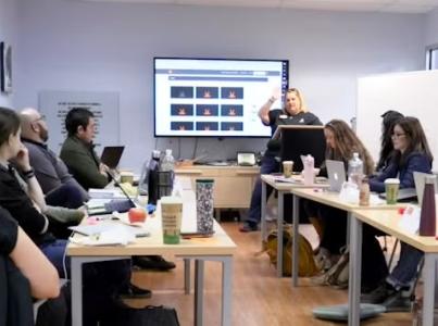 Students in a classroom listening to the teacher.